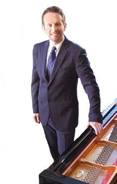Jonathan Swanson standing at piano